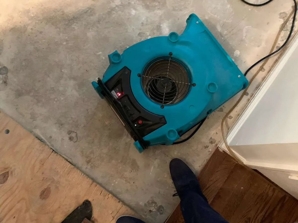 Air mover drying subfloor during Commercial Water Damage Restoration in Fort Meade